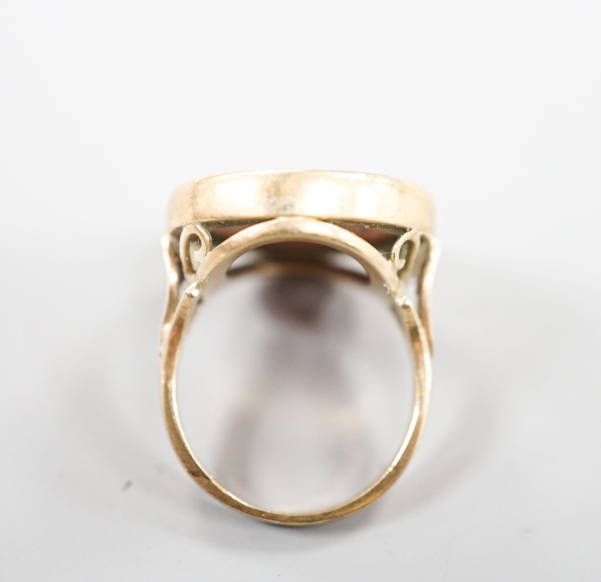 An early 20th century 9ct and intaglio brown chalcedony set ring, carved with the bust of a lady to dexter, size Q, gross weight 8.4 grams.